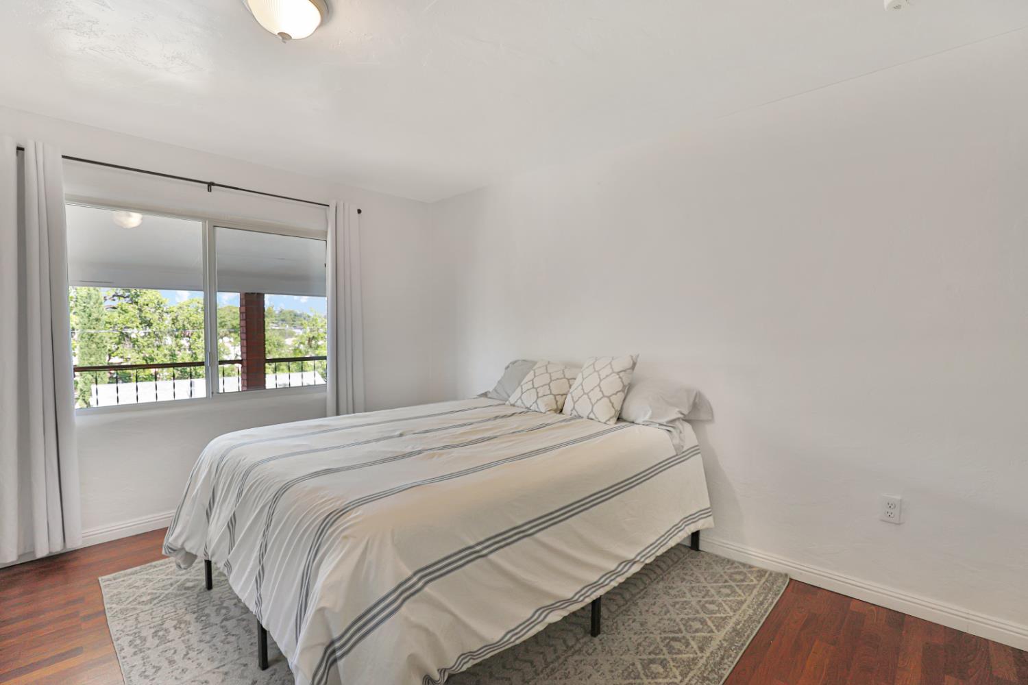 207 Peek Street Jackson, CA 95642 - Photo 14 of 30 a bedroom with a bed and a window