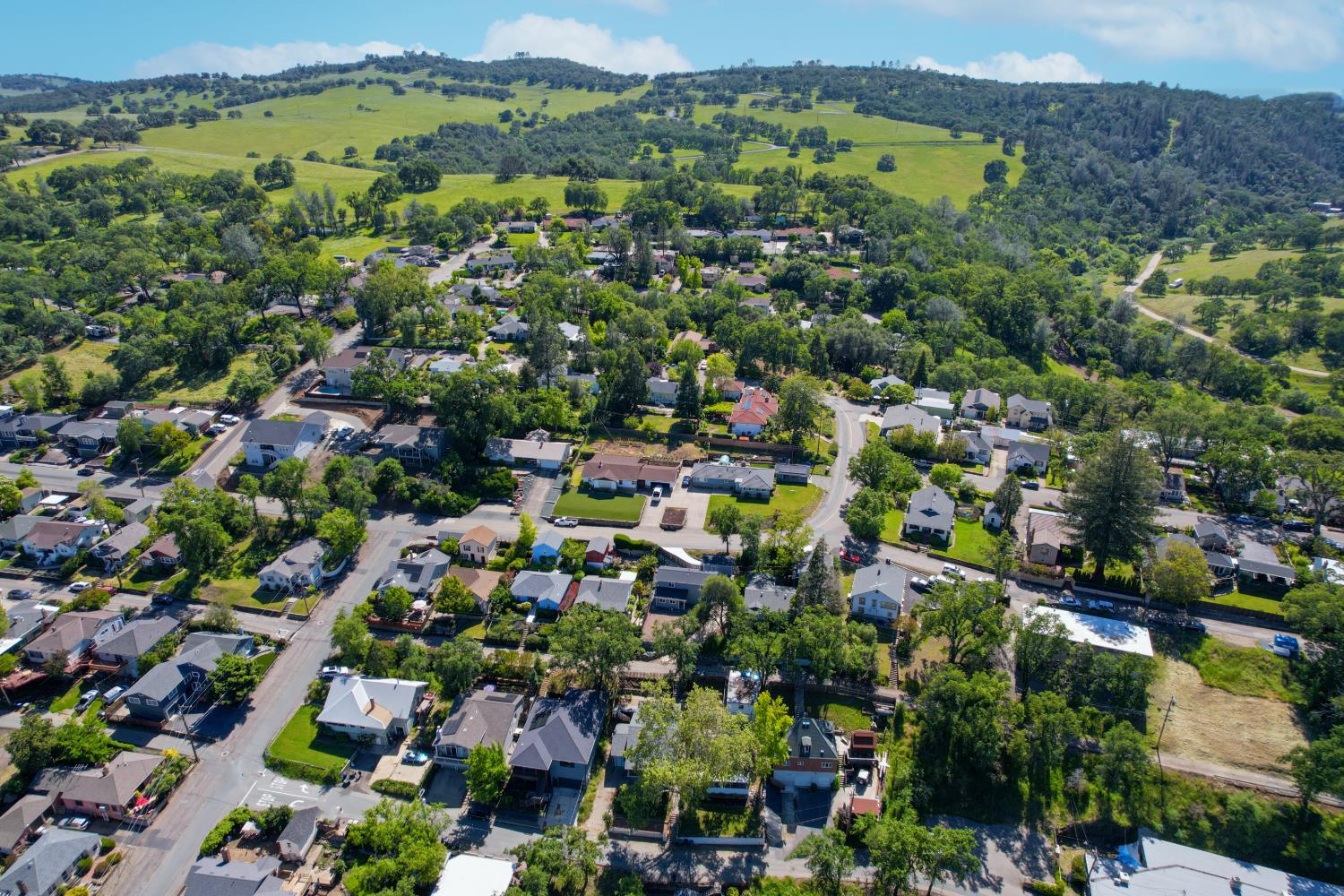 207 Peek Street Jackson, CA 95642 - Photo 5 of 30 an aerial view of a city with lots of residential buildings and mountain view in back