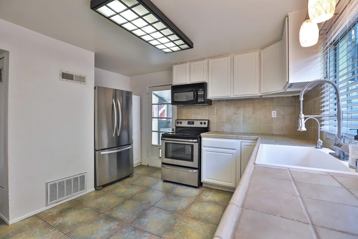207 Peek Street Jackson, CA 95642 - Photo 10 of 30 a kitchen with stainless steel appliances granite countertop a refrigerator and a sink
