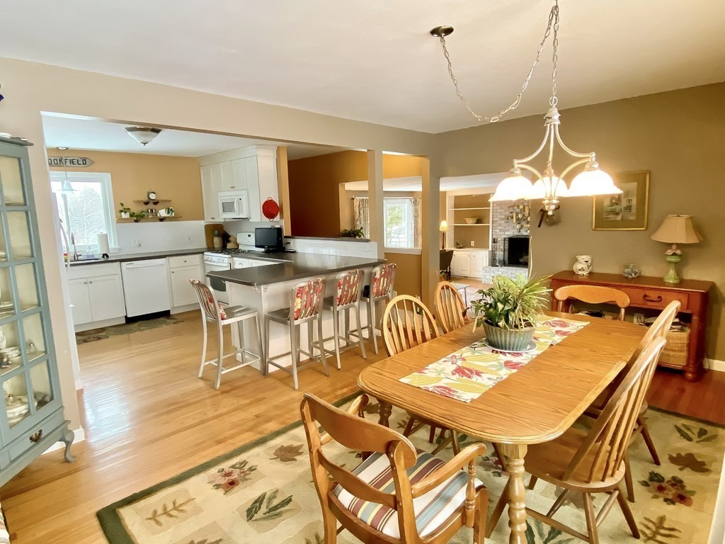 992 Tinkham Road Wilbraham, MA 01095 - Photo 3 of 33 a dinning table and chairs in a open kitchen