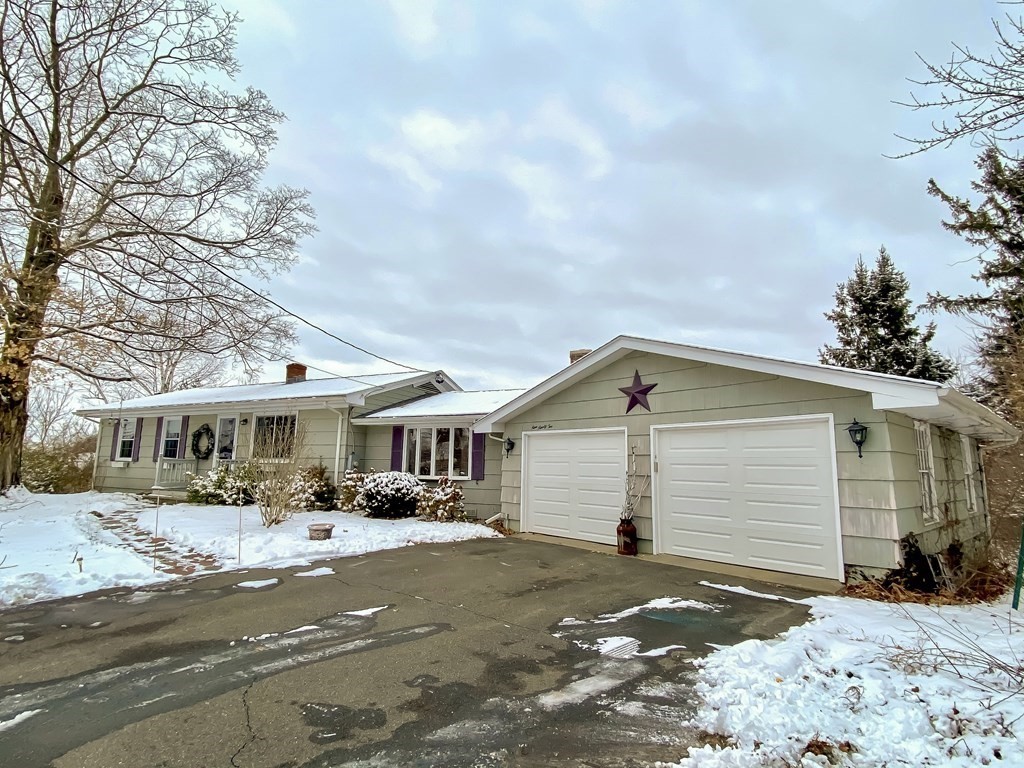 992 Tinkham Road Wilbraham, MA 01095 - Photo 33 of 33 a front view of a house with a yard and garage