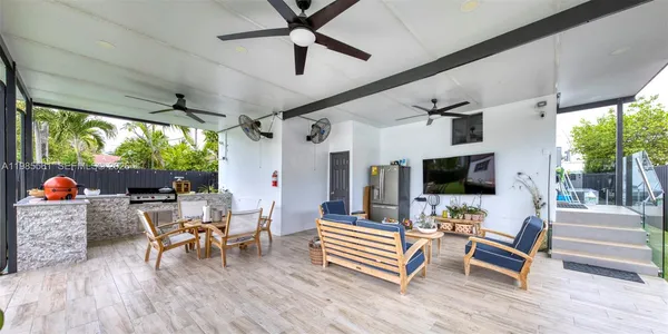 a backyard of a house with table and chairs