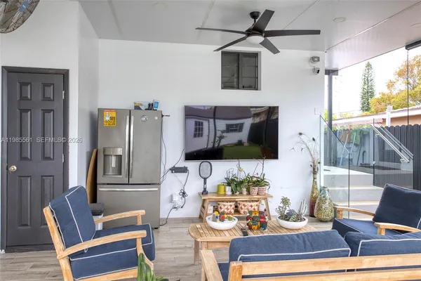 a backyard of a house with table and chairs