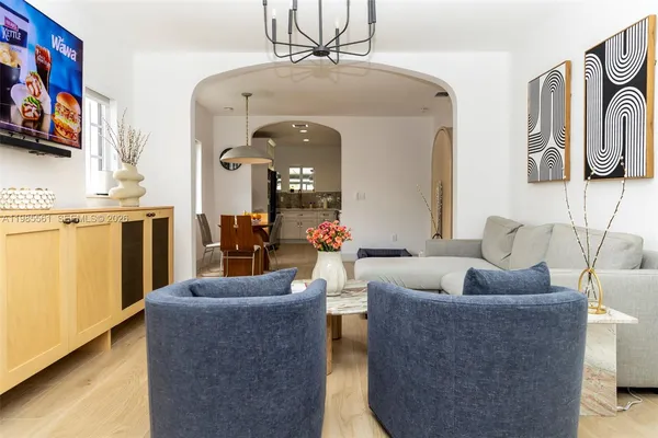 a living room with furniture and a chandelier