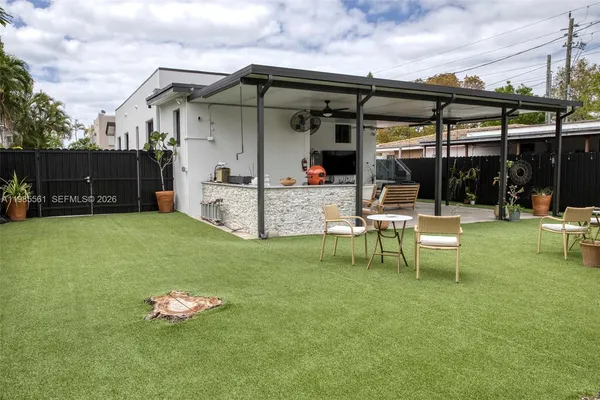 a backyard of a house with table and chairs
