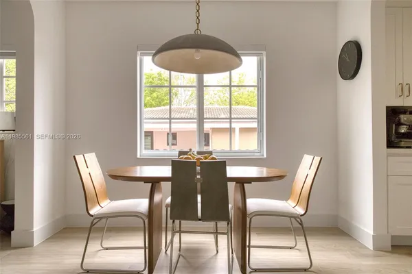 a dining room with furniture and window