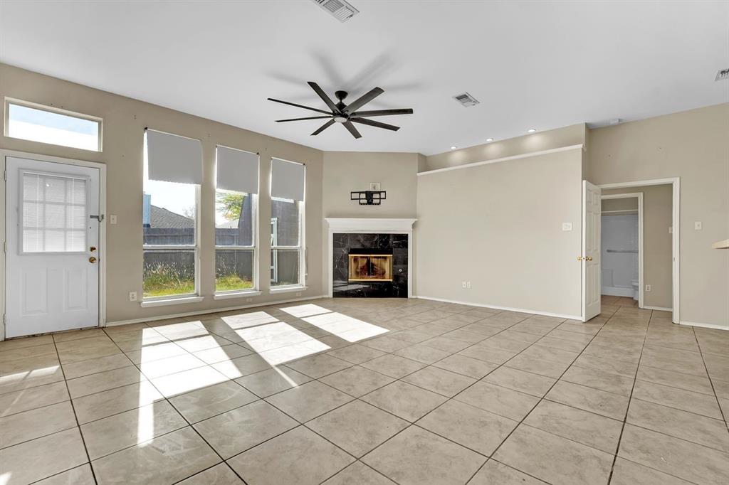 1708 Windcastle Drive Mansfield, TX 76063 - Photo 11 of 28 a view of an empty room with a fireplace and a window