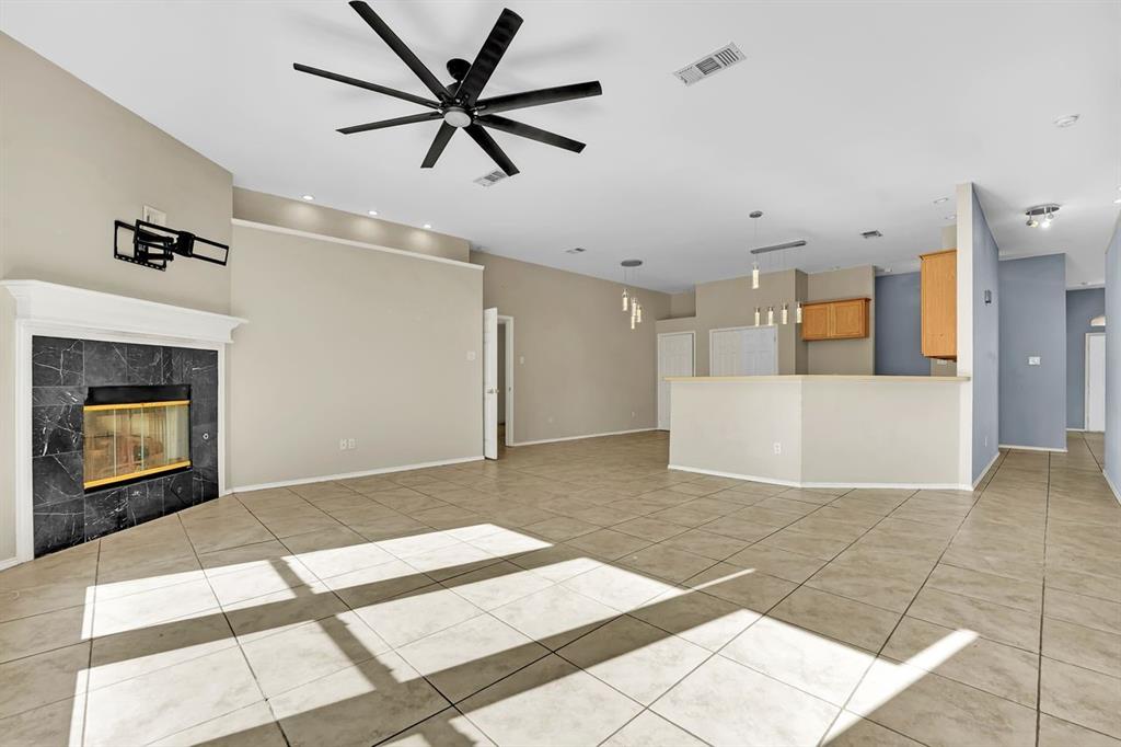 1708 Windcastle Drive Mansfield, TX 76063 - Photo 12 of 28 a view of a livingroom with a ceiling fan and kitchen view