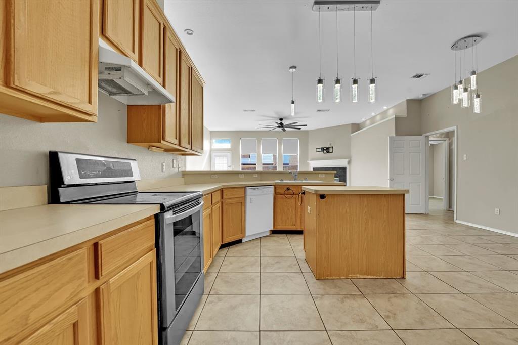 1708 Windcastle Drive Mansfield, TX 76063 - Photo 16 of 28 a kitchen with stainless steel appliances granite countertop a sink counter top space cabinets and a stove top oven