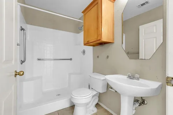 a bathroom with a sink toilet and shower