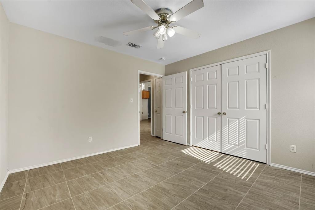 1708 Windcastle Drive Mansfield, TX 76063 - Photo 19 of 28 a view of an empty room with a ceiling fan