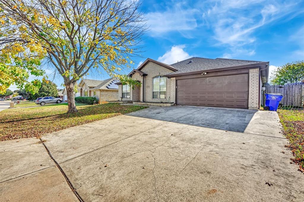 1708 Windcastle Drive Mansfield, TX 76063 - Photo 2 of 28 a front view of a house with a yard and garage