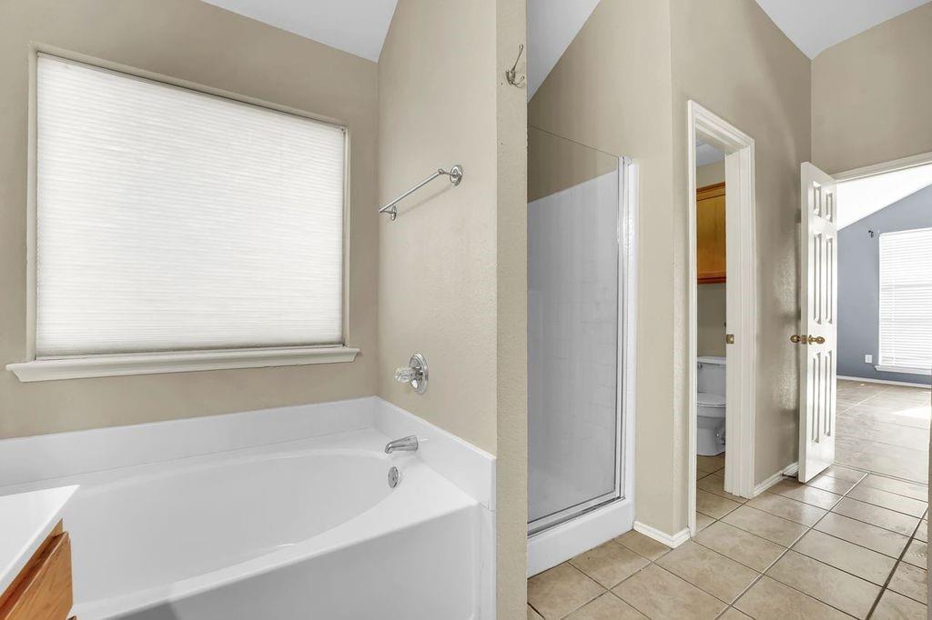 1708 Windcastle Drive Mansfield, TX 76063 - Photo 24 of 28 a bathroom with a bathtub and shower