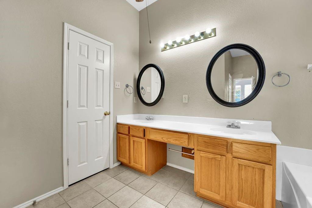 1708 Windcastle Drive Mansfield, TX 76063 - Photo 25 of 28 a bathroom with a sink and a mirror
