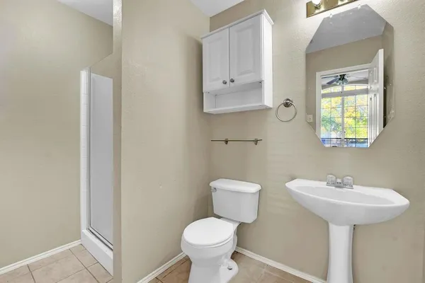 a bathroom with a sink toilet and a mirror