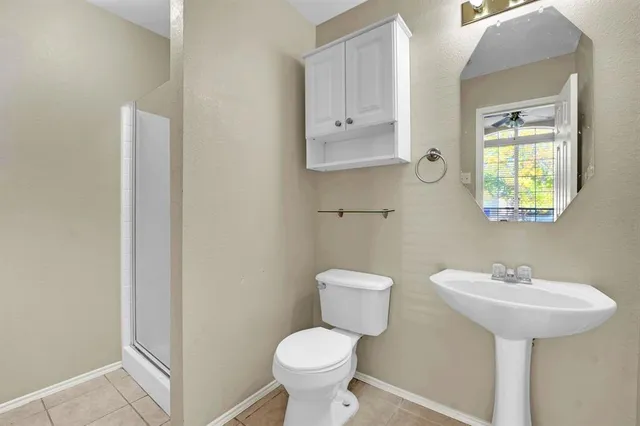 a bathroom with a sink toilet and a mirror