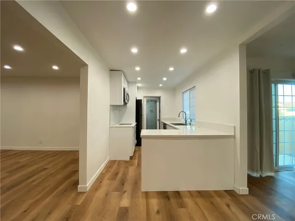 a view of kitchen with wooden floor