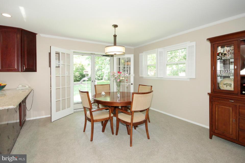 5952 Atteentee Road Springfield, VA 22150 - Photo 8 of 30 a dining room with furniture a chandelier and wooden floor