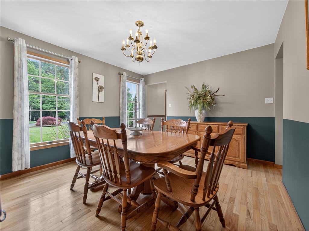 853 Lahr Road Nazareth, PA 18064 - Photo 5 of 29 A refined dining space with warm hardwood floors and a striking chandelier, ideal for entertaining.