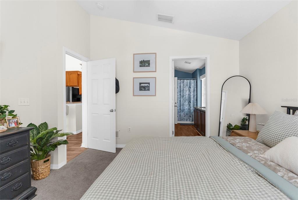 8546 Great Egret Trace New Port Richey, FL 34653 - Photo 13 of 21 a bedroom with bed and a potted plant