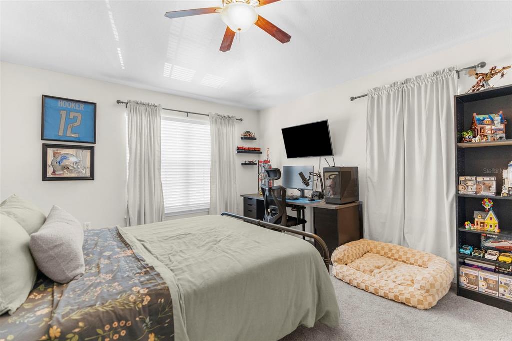 8546 Great Egret Trace New Port Richey, FL 34653 - Photo 15 of 21 a bedroom with a bed and a flat screen tv