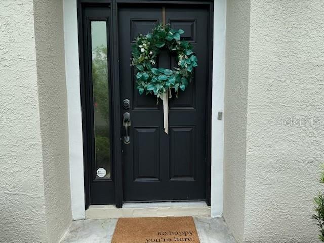 8546 Great Egret Trace New Port Richey, FL 34653 - Photo 2 of 21 a view of a potted plant in front of a door