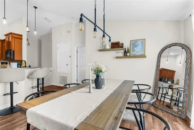 a view of a kitchen with kitchen island dining table and stainless steel appliances