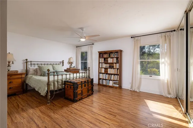 a view of a bedroom with furniture and wooden floor