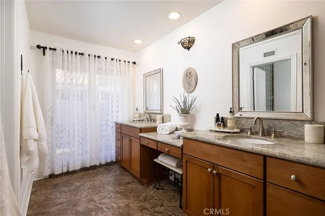 a bathroom with double vanity sink and a mirror