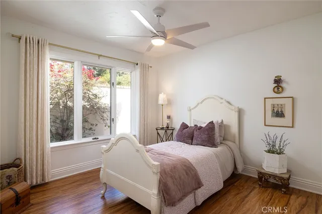 a bedroom with a bed and a large window