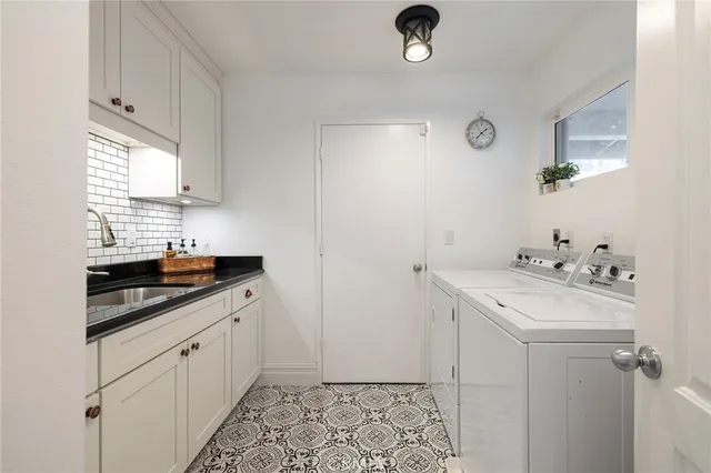 a room with a sink and cabinets