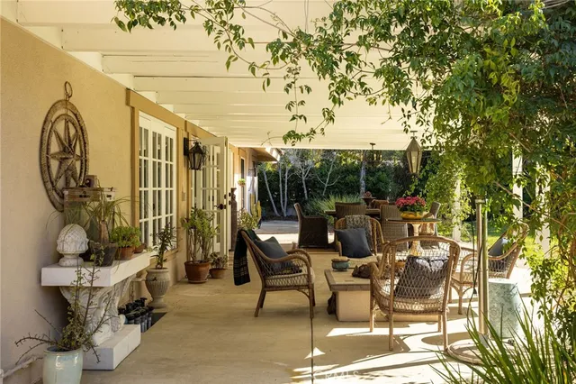 a view of a patio with table and chairs and potted plants