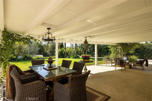 a view of an outdoor dining space with a table and chairs