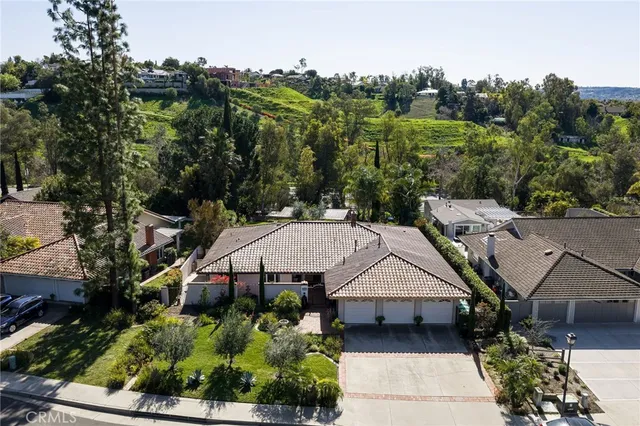 an aerial view of a house with a big yard and large tree