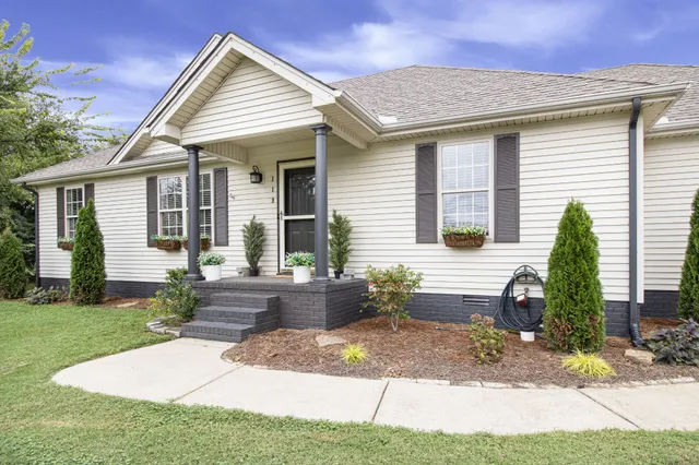 a front view of a house with garden