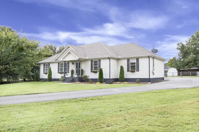 a front view of a house with a garden and porch