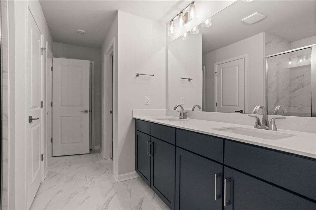 629 Sweetspire Trail, Unit 149 Seneca, SC 29678 - Photo 22 of 30 A well-appointed primary bathroom showcases a double vanity with ample counter space and modern fixtures.