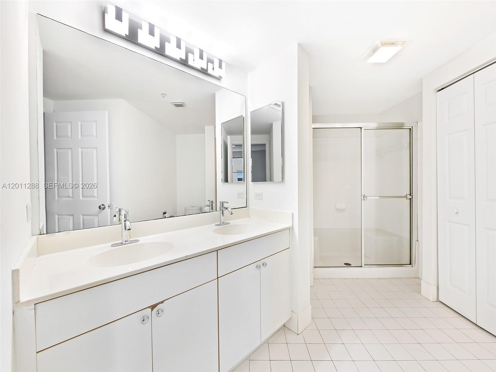 17100 North Bay Road, Unit 1614 Sunny Isles Beach, FL 33160 - Photo 11 of 17 a bathroom with a sink and a mirror