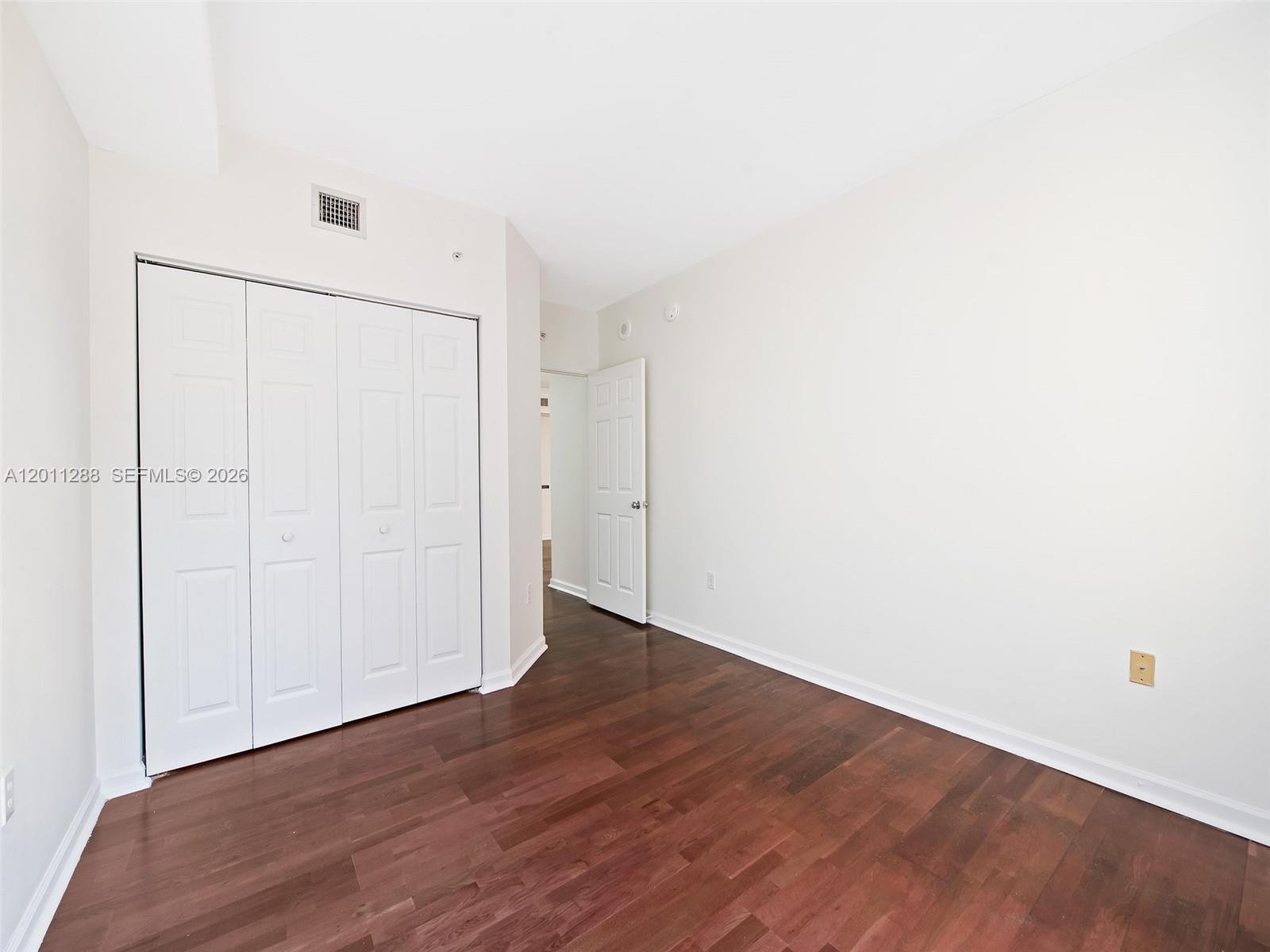 17100 North Bay Road, Unit 1614 Sunny Isles Beach, FL 33160 - Photo 12 of 17 a view of an empty room with wooden floor