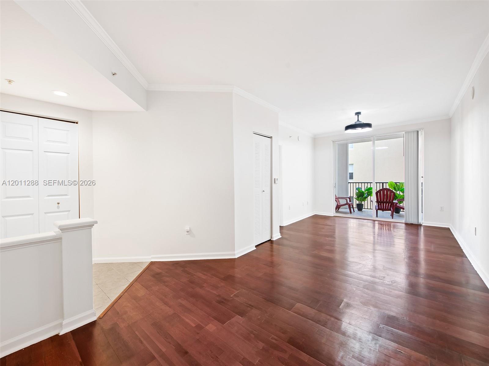 17100 North Bay Road, Unit 1614 Sunny Isles Beach, FL 33160 - Photo 4 of 17 a view of empty room with wooden floor and kitchen view