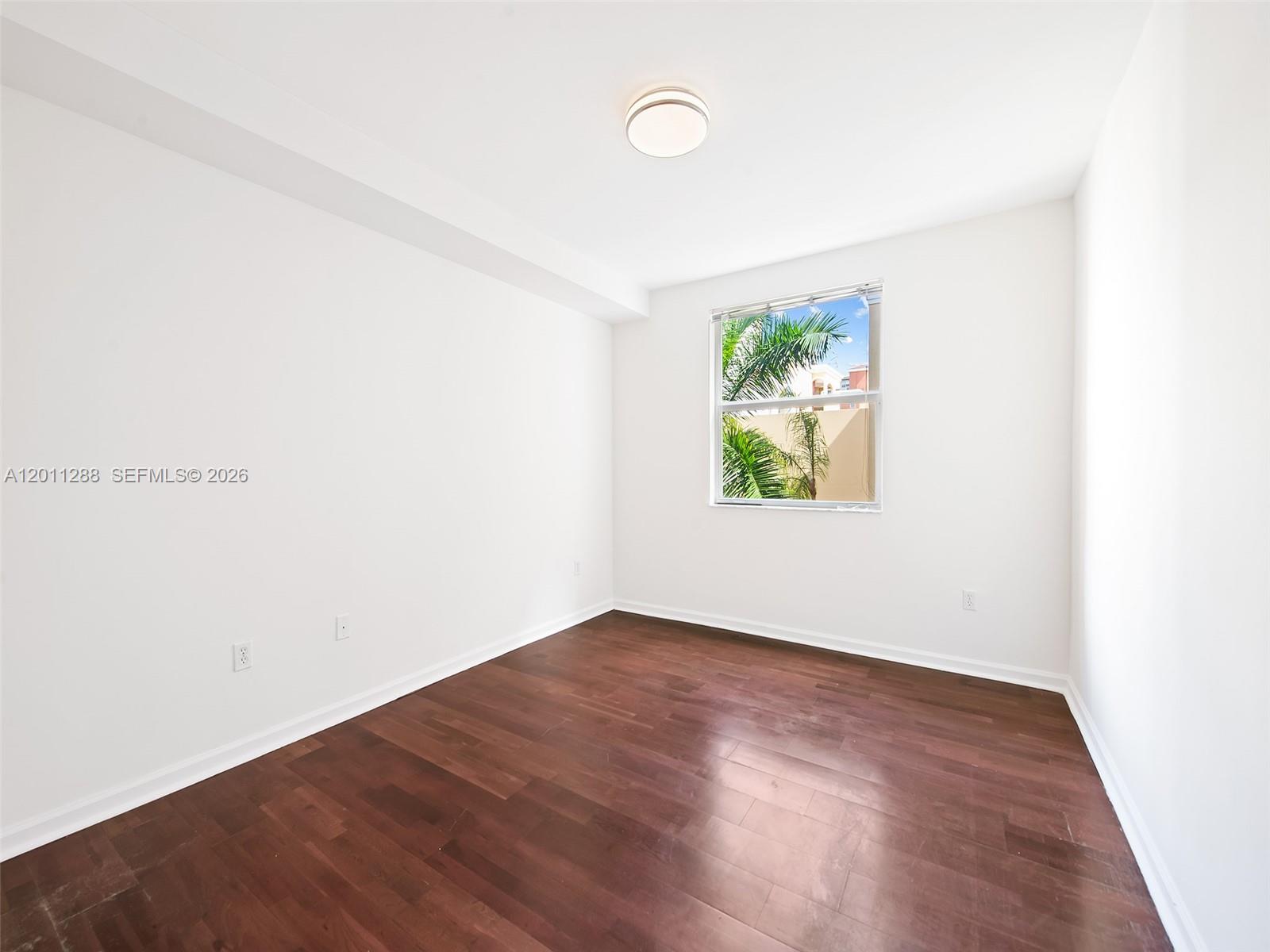 17100 North Bay Road, Unit 1614 Sunny Isles Beach, FL 33160 - Photo 8 of 17 an empty room with wooden floor and window