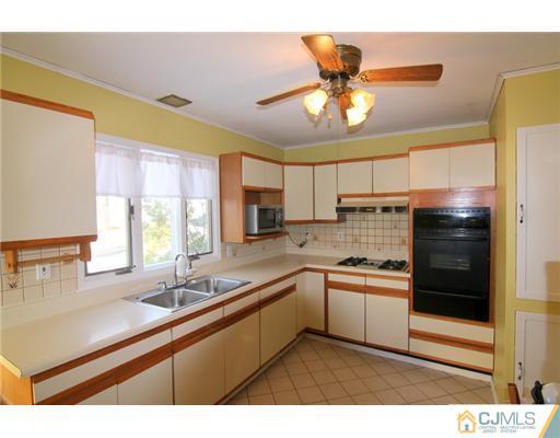 9 Cannon Road East Brunswick, NJ 08816 - Photo 2 of 7 a kitchen with a sink stainless steel appliances and window