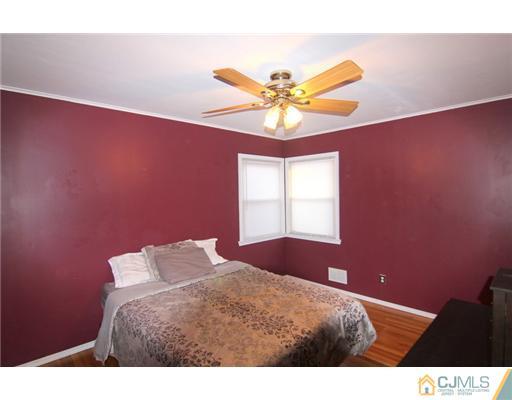 9 Cannon Road East Brunswick, NJ 08816 - Photo 4 of 7 a bedroom with a bed and a chandelier
