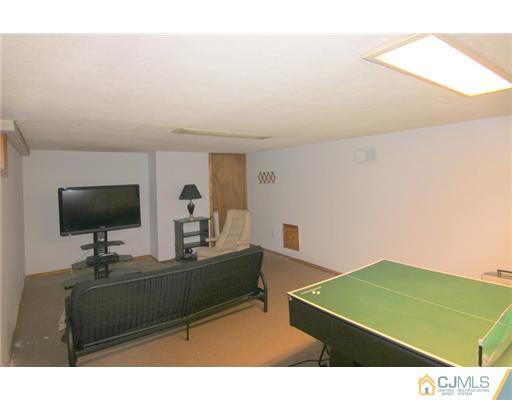 9 Cannon Road East Brunswick, NJ 08816 - Photo 6 of 7 a living room with furniture and a flat screen tv