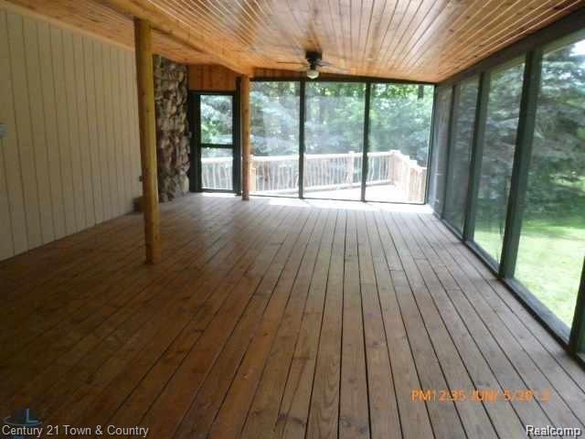 299 North Baldwin Road Oxford, MI 48371 - Photo 28 of 33 COVERED SCREENED IN PORCH OUT TO DECK
