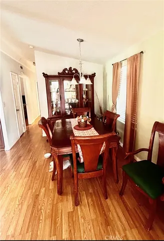 a dining room with furniture and wooden floor