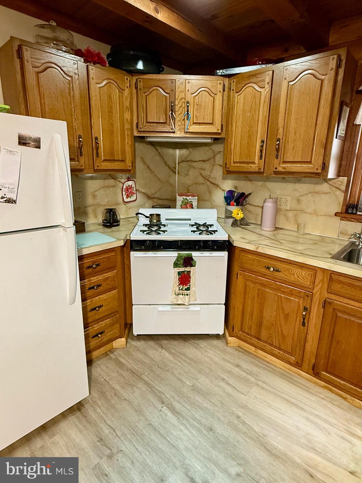 236 Fremont Road Nottingham, PA 19362 - Photo 21 of 34 a kitchen with wooden cabinets and white appliances