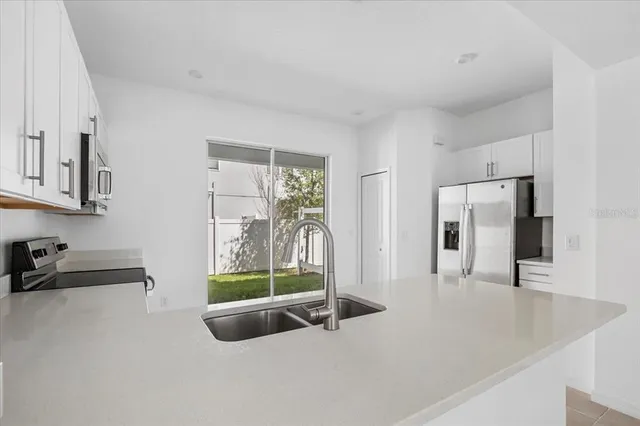 a living room with furniture and a floor to ceiling window