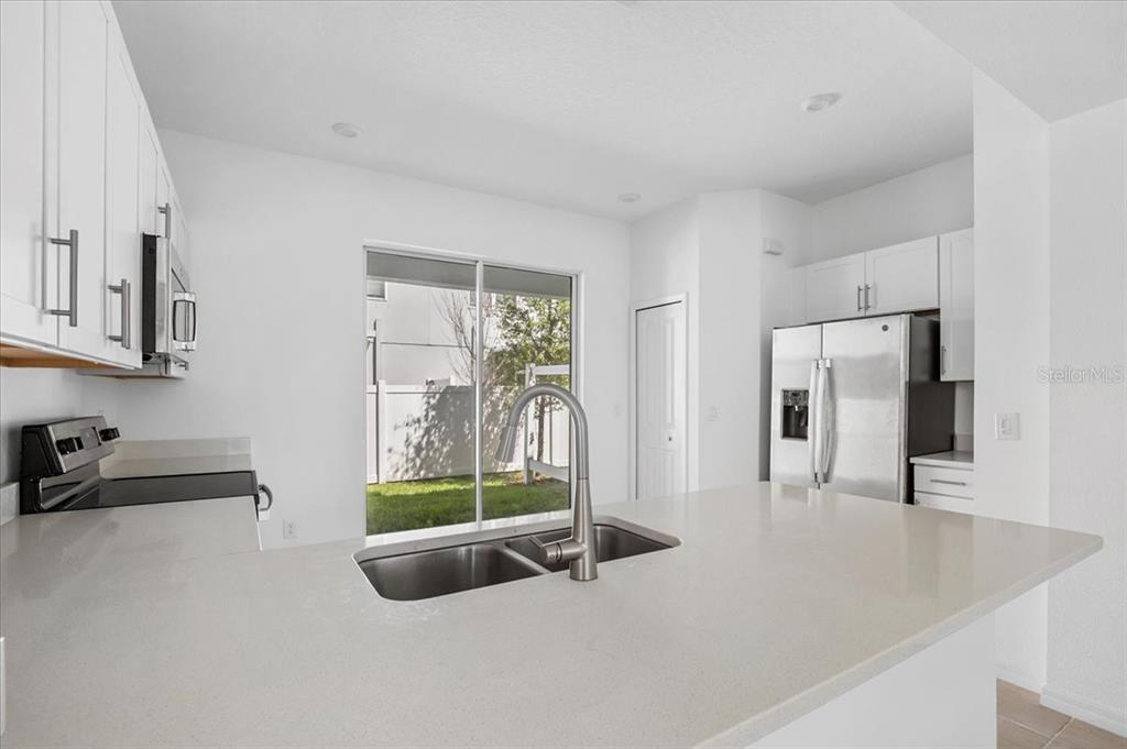 6338 Fairmont Lane Palmetto, FL 34221 - Photo 11 of 39 a living room with furniture and a floor to ceiling window