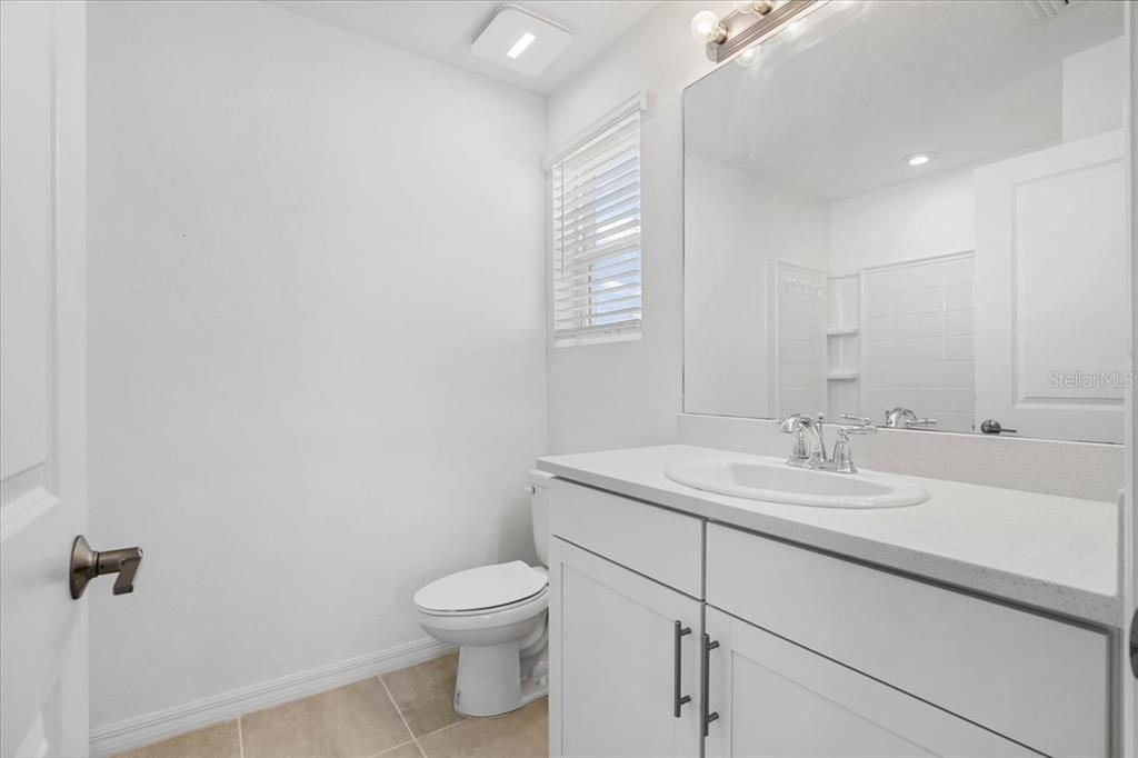 6338 Fairmont Lane Palmetto, FL 34221 - Photo 19 of 39 a bathroom with a granite countertop sink mirror and toilet